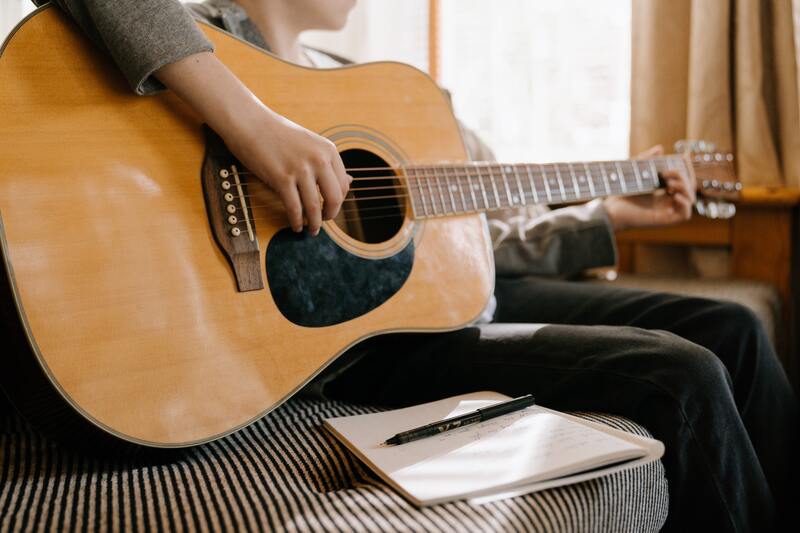 https://www.pexels.com/photo/person-playing-brown-acoustic-guitar-4708902/