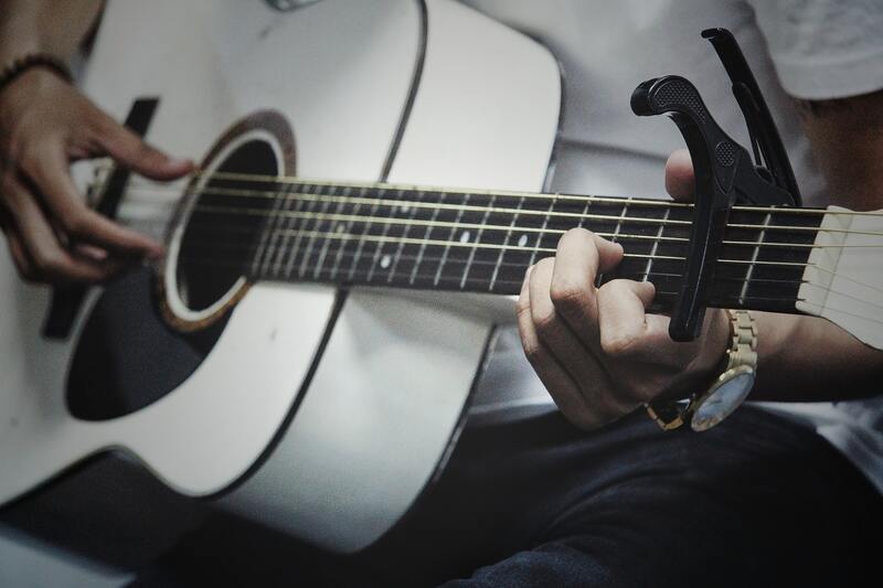 https://www.pexels.com/photo/man-holding-a-white-dreadnought-acoustic-guitar-941674/